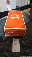 Top of original Lionel box with large white Lionel logo on orange background