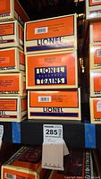 Stack of Lionel Electric Trains boxes including US Army Bunk Car 19678 visible on label.