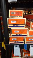 Stack of four Lionel train car boxes showing product numbers and descriptions.