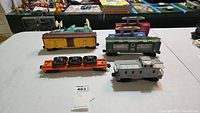 Overview of five Lionel train cars on table