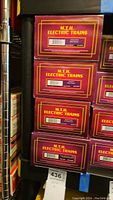 Stack of boxed MTH Electric Trains cars showing front barcode labels.