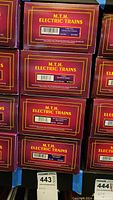 Stack of multiple M.T.H. Electric Trains caboose boxes showing varied models