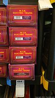 Stacked boxes showing MTH Electric Trains branding and model numbers for four O scale hopper cars.