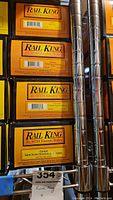 Photo showing stacked Rail King boxes with labels for each model train car included in the lot.