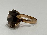 Angled front-left view showing the ring’s high-profile six-prong setting and band profile.