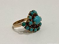 Left-side profile of ring showing gold band and cluster setting