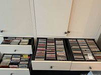 Three drawers of CDs arranged vertically