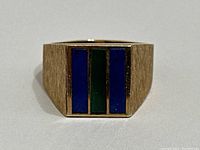 Front-facing view of rectangular top showing three vertical inlaid panels—blue lapis lazuli on sides and green jade in center.