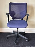 Front view showing mesh backrest, seat cushion, armrests and base
