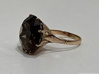 Side view showing large smoky topaz gemstone and decorative prong gallery