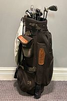 Front view of Cobra Outback bag filled with clubs and towel