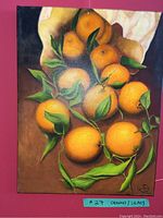 Photo of oil painting featuring a still life of oranges with green leaves on canvas