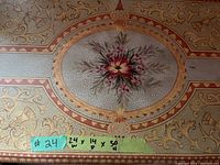 Close-up photo of the top surface showing detailed ornamental floral painting with measurement tag 24x14x30 inches.