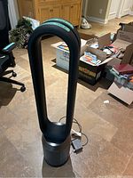 Full front view of tower fan with oval loop amplifier and base.