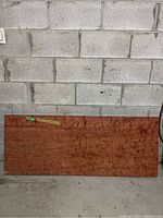 Full frontal view of entire marble slab leaning against cinder block wall