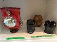 All four items displayed on white shelf with green tape labels