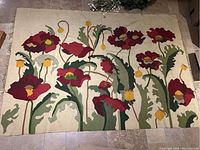 Full view of large woven tapestry displaying red and yellow poppies with green foliage on a beige background. Shows overall condition and design.