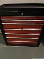 Front view of the red and black multi drawer toolbox with lock and metal handles
