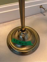 Close up of the lamp's base with a green tape label showing dimensions 44 x 12