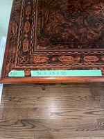 Close-up of the corner of the wooden table showing the measurement sticker 36 x 28 x 30 inches and edge details