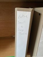 Photo of coin collector album spine labeled 'Extra small & large pennies'