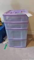 Front view of the plastic storage drawers showing the four drawers and top compartments.