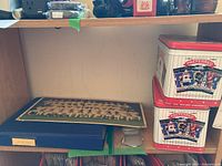 Photo of blue sports card album and two vintage Preferred Baseball Card tins stacked