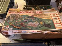 Top view of the original train set box showing box artwork and branding of Rugged Mountain Railway, indicating a complete and ready to run HO scale electric train set.