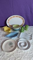 Overview of colorful MCM appetizer dishes including melamine platter and various bowls and plates arranged on table