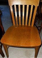Front view of Amish Ridge Field dining chair with contoured wooden seat and vertical slat back.