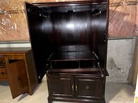 Cherry wood entertainment centre armoire, front with open upper and lower compartments showing shelves and cabinet doors.