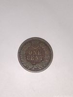 Reverse side of the coin showing the laurel wreath and 'ONE CENT' inscription with shield above.