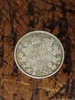 Back of the coin showing crown, denomination "10 CENTS CANADA" and date "1909" inside a wreath.