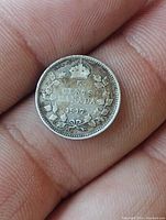 Reverse image of the 1917 Canadian 5 cent silver coin with denomination, date, crown, and wreath details.