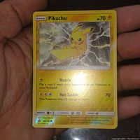Photo of the front of the Angry Pikachu reverse holo foil card held in hand showing card details and condition.