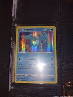 Photo of the Articuno holographic Pokemon card inside a protective binder sleeve.