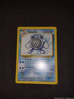 Photo of a single original Base Set Poliwhirl Pokemon card with yellow border and blue background, showing Poliwhirl image and attack details.