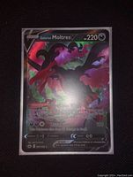 Front view of a Galarian Moltres V Pokémon card in full art style with holo foil surface showing vibrant colors and effects.