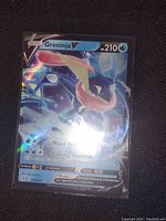 Photo of a Greninja V Full Art Holo Foil Pokemon card, showing front view of the card in protective sleeve.