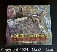 Front cover showing book title 'Robert Bateman Natural Worlds' with illustrated otters on rocks.
