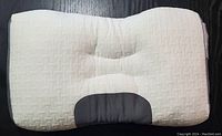 Front view of the 15x24 inch white textured massage pillow with black mesh panel at the bottom