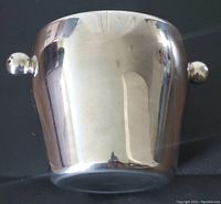 Full view of the polished stainless steel ice bucket showing shape and two side handles.