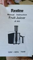 Instruction manual of Realine JE 803 Fruit Juicer showing model and power specs.