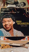 Dinah Washington LP cover showing the album title The Swingin' Miss 'D' with her portrait, classic vintage record shown in a worn state.