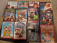 Full view of 12 DVD cases arranged on carpet, showing movie titles and cover art