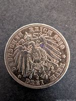 Obverse side showing Deutsches Reich eagle and 1910 Drei Mark inscription.