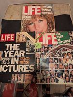 Three LIFE magazines stacked and spread showing covers of Winter 1978, Special Issue 1982, and December 1983 editions.