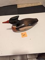 Top angle view of the carved wooden duck decoy showing color and shape.