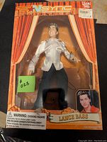 Front view of Lance Bass doll in original Living Toyz packaging with stage curtain design and photo of Lance Bass