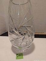 Clear crystal vase showing pinwheel engraving and overall shape.